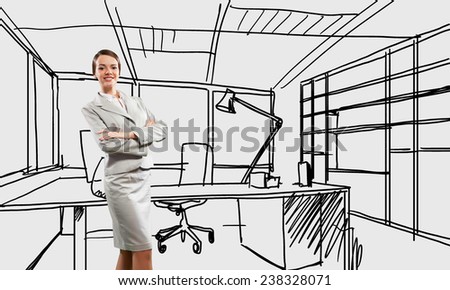 Young confident businesswoman standing in drawn office