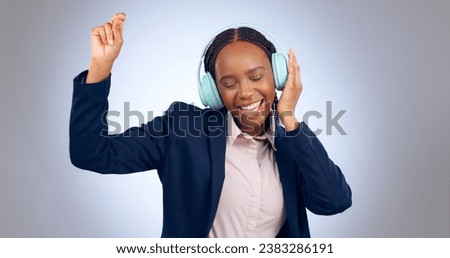 Dance, headphones and business woman in studio for celebration, freedom and excited for winning on grey background. Happy african worker listening to music, audio or streaming radio sound with energy
