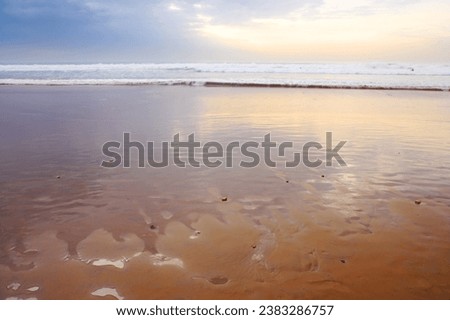 Seascape and landscape of a golden sunset on the west coast of Jutland in Loekken, Denmark. Beautiful cloudscape on an empty beach at dusk. Clouds over the ocean and sea in the evening with copyspace