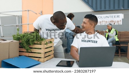 Team, volunteer and laptop for donation, charity and outreach program by people outdoor. Tech, collaboration and men in nonprofit, support and social responsibility, community service and NGO Royalty-Free Stock Photo #2383287197