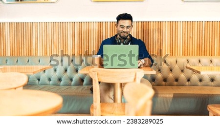Man in cafe, typing on laptop and remote work, reading email and writing blog, article and research in restaurant. Computer, freelancer and editor in coffee shop, store and tech for internet at table