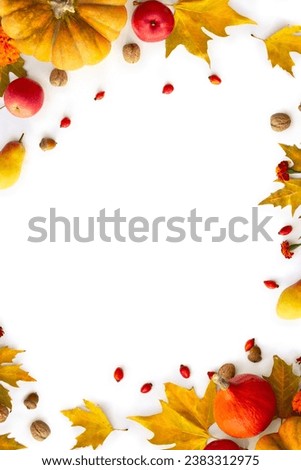 Pumpkin, acorns, red berries, apples and autumnal colorful maple leaves on a white background with space for text . Top view, flat lay