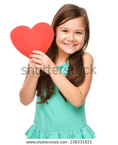 Portrait of a little girl holding red heart, isolated over white