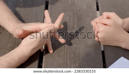 Close-up hands during discourse time. Gesture nonverbal form of communication during conversation that convey meanings, emotions, ideas. Gestures enhance spoken language, young people body details.  Royalty-Free Stock Photo #2383330155