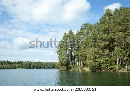The scenic view of Baltis Lake with forest trees in early Autumn (Lithuania). Royalty-Free Stock Photo #2383330721