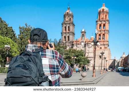 Mexican tourist in San Luis Potosi downtown taking pictures to cathedral church