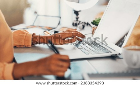 Graphic designer, blogger and young entrepreneur working on a laptop while designing a logo or website while drawing with a digital stylus pen. Hands of a creative woman using modern digital tools