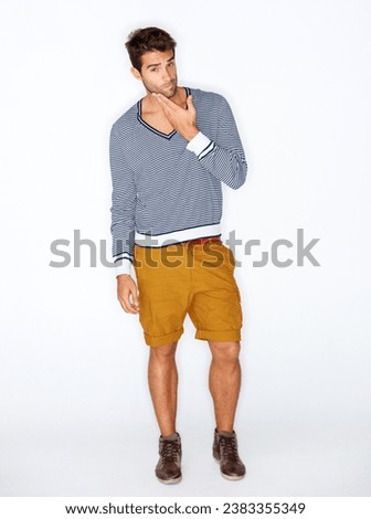 Handsome, portrait and a man with fashion on a white background for style, trendy and cool. Unique, stylish and a confident guy or model with clothes, shorts or casual clothing on a studio backdrop