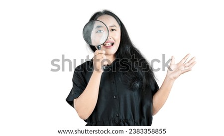 Excited happy asian woman found something good, looking through magnifying glass with pleased smile isolated on white background