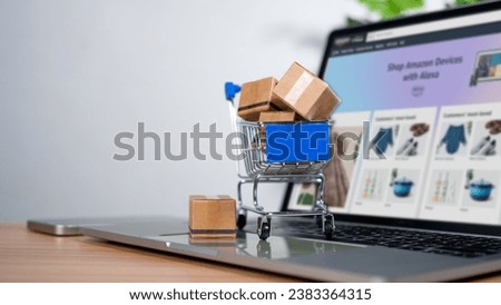Cart and box icon on laptop computer on white background. Online shopping, marketplace platform website, e-commerce technology, dropshipping, logistics, and online payment concept.
