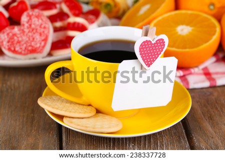Cup of tea with card on table close-up