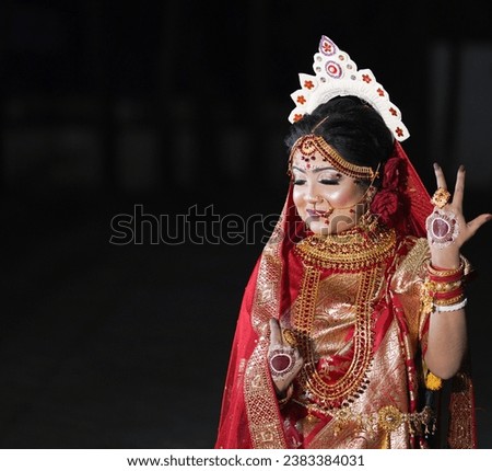 A Bridal Vision Come to Life A Mesmerizing Portrait of an Indian Bengali Hindu Bride, Resplendent in Tradition and Poised to Begin Her New Life Journey Royalty-Free Stock Photo #2383384031