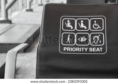 Empty seats, Black colored priority seats in international airport reserved for disability, pregnant, child, senior people and monk. Set of priority seats.