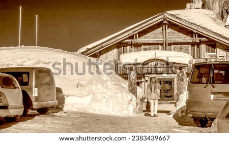 Wooden Hut in the middle of a valley covered by snow in winter season. Infrared view