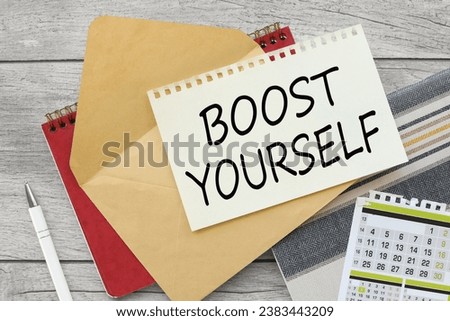 sheet of paper on an envelope on a red notepad. calendar. text Boost yourself.