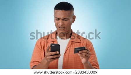 Man, credit card and phone in studio, frustrated face or confused with thinking, fintech and blue background. Person, smartphone and online shopping with glitch, payment decline and fail with banking Royalty-Free Stock Photo #2383450309