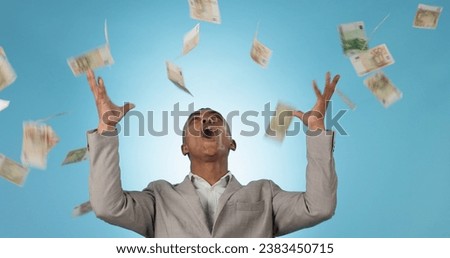 Business man, winner and money rain for success, celebration and lottery, bonus or financial freedom on a blue background. Excited worker or entrepreneur in studio with wow and yes for cash in air