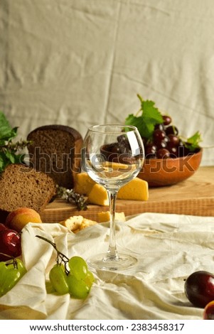 a glass of red wine and a bottle on the table