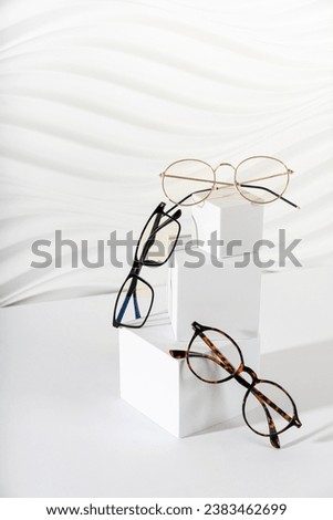 Trendy eyeglasses in plastic and metallic frame on a white background. Close up. Sunglasses and spectacles sale concept. Optic shop promotion banner, poster. Eyewear fashion. Minimalism. Vertical Royalty-Free Stock Photo #2383462699