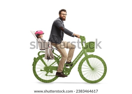 Bearded man riding a child on a green bicycle and looking at camera, sustainable mobility concept 