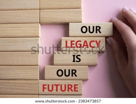 Our Legacy is our Future symbol. Concept words Our Legacy is our Future on wooden blocks. Businessman hand. Beautiful pink background. Business concept. Copy space