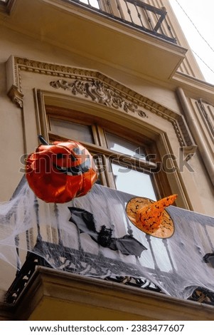 Granada, Spain - October 22, 2023: Decorations and decorations on a balcony in Granada for Halloween with red spooky pumpkins, skeletons, ghosts, cobwebs, bats and black spiders