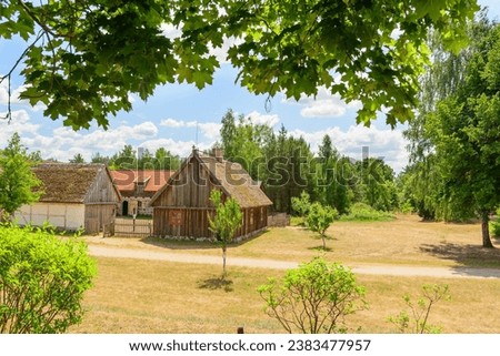 Small cozy houses. Wooden ancient buildings. Summer village and vacation. Farm bio products.