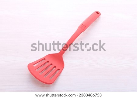 red cooking utensils on a bright background