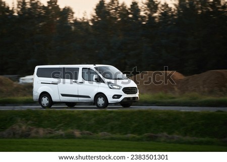 Commercial van on the road. Delivery van close-up mockup isolated. Final destination shipping truck mock-up. Royalty-Free Stock Photo #2383501301