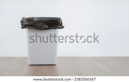 Rubbish bin side view. Empty Garbage Bin Banner.  Waste Bin on wooden flool with white background. Waste concept. Royalty-Free Stock Photo #2383506567
