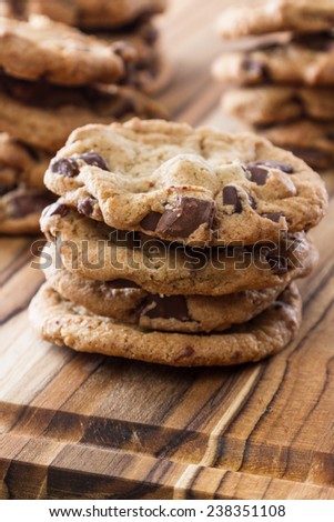 close up of home made chocolate chip cookies on a wooden table