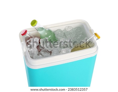 Modern beach cooler with ice cubes and bottles of cold drink on white background
