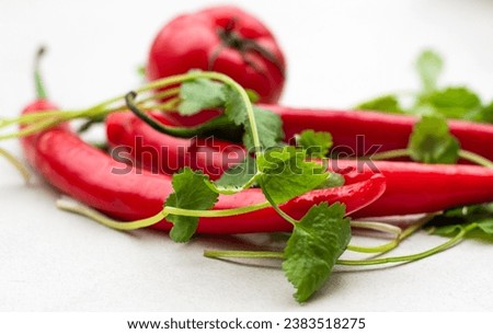 A group of red peppers and tomatoes decorated with corianders