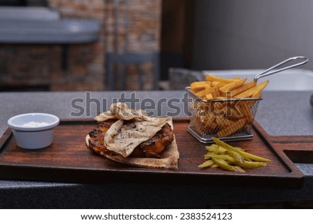 a picture of fried potato chips and chicken place on the table