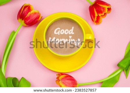 Top view coffee cup and tulips on pink background. Spring good morning card.