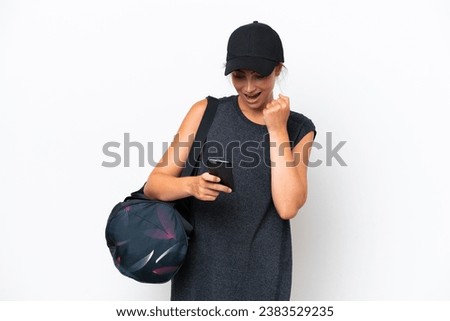 Young sport woman with sport bag isolated on white background surprised and sending a message
