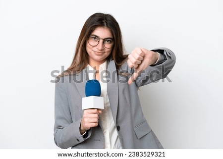 Young caucasian TV presenter woman isolated on white background showing thumb down with negative expression Royalty-Free Stock Photo #2383529321