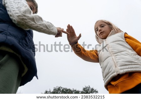 Children playing rock paper scissors