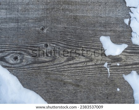 Grey weathered vintage wooden texture background with patches of snow, winter decoration background design