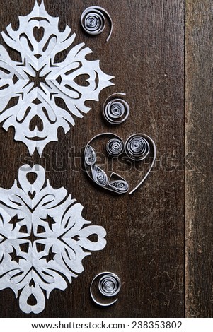 Snowflakes out of paper on wood background. Christmas. New Year.