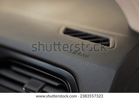 Safety airbag sign and air vent inside car, closeup
