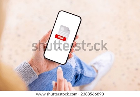 Person holding mobile phone with 
PDF file icon on the screen Royalty-Free Stock Photo #2383566893
