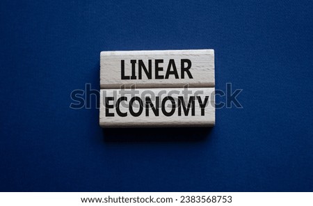 Linear Economy symbol. Concept words Linear Economy on wooden blocks. Beautiful deep blue background. Business and Linear Economy concept. Copy space. Royalty-Free Stock Photo #2383568753