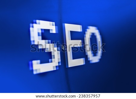 SEO ( search engine optimization ) big title on computer screen. Blue background color. Vignette light and dark shadow dramatic effect. 