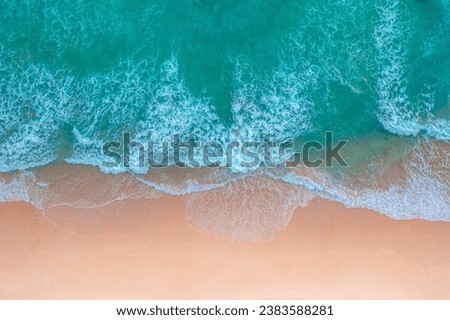 

aerial view White foam waves in the green sea lapping on the white sandy beach.
Wave after wave swept towards the shore.Freedom beach Patong Phuket Thailand. 
sea waves crashing on shore background
 Royalty-Free Stock Photo #2383588281