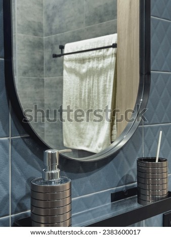 modern fashionable stylish interior of a toilet room in dark colors, tiles, sanitaryware, shower, washbasin and mirror