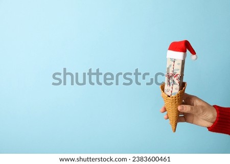 Ice cream cone with a gift and Santa's hat
