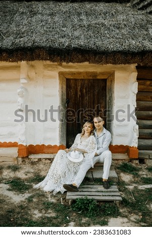 a young couple spends time together against the background of historic windmills