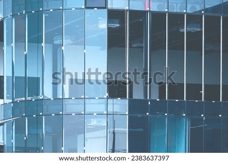 Incomplete curve glass wall outline structure of modern building is under construction Royalty-Free Stock Photo #2383637397