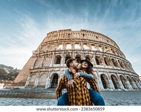 Happy young romantic couple having fun together in Rome Colosseum - Love relationship and travel lifestyle concept Royalty-Free Stock Photo #2383650859